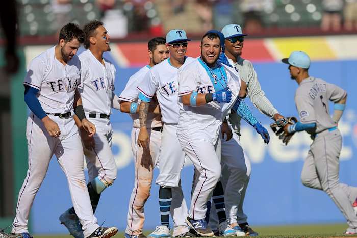 Jun 17, 2018; Arlington, TX, USA; Texas Rangers catcher Jose Trevino (71) celebrates with his teammates after his game winning 2-run single against the Colorado Rockies at Globe Life Park in Arlington. Mandatory Credit: Andrew Dieb-USA TODAY Sports